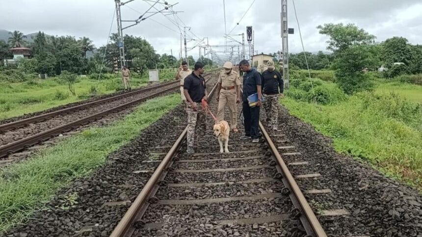 Police officers interrogate suspects in the Raigad murder case, sitting across a table with case files and a mobile phone.